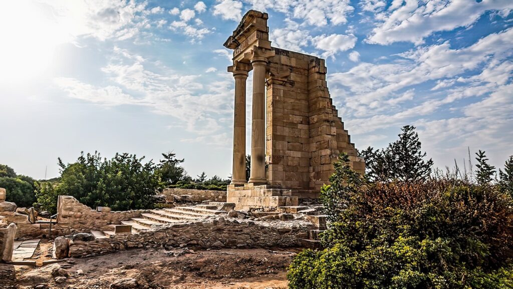 Ruins of the Temple of Apollo Hylates against a cloud-dappled sky in Cyprus, emblematic of Hellenistic and Roman historical periods.