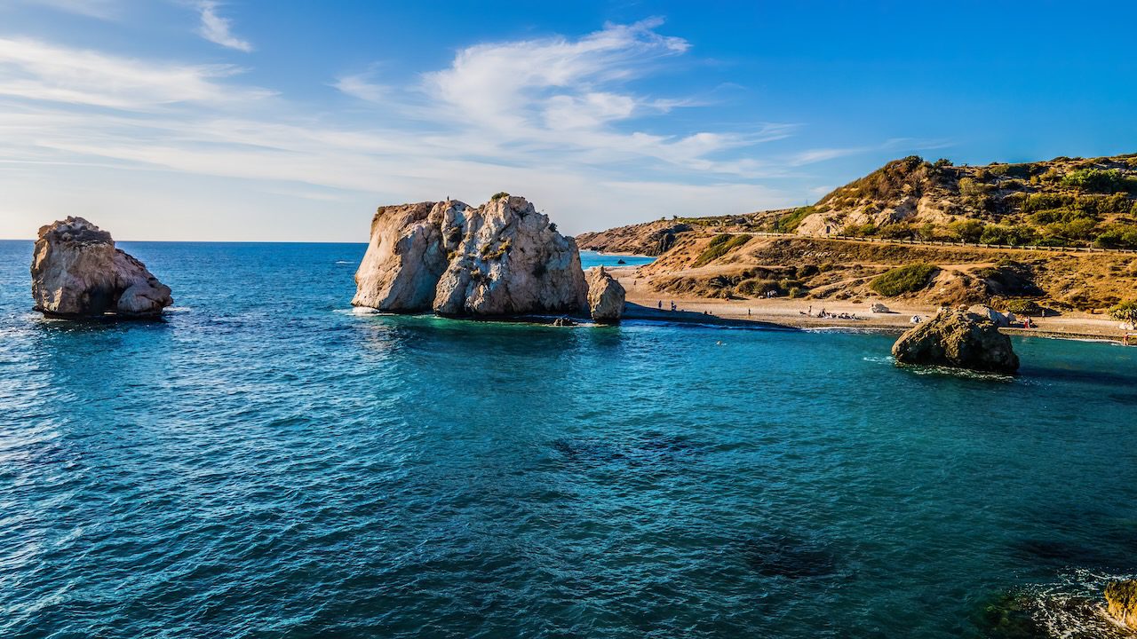 Iconic Aphrodite's Rock, entwined with Cyprus's history, rises majestically from the sea near Paphos.