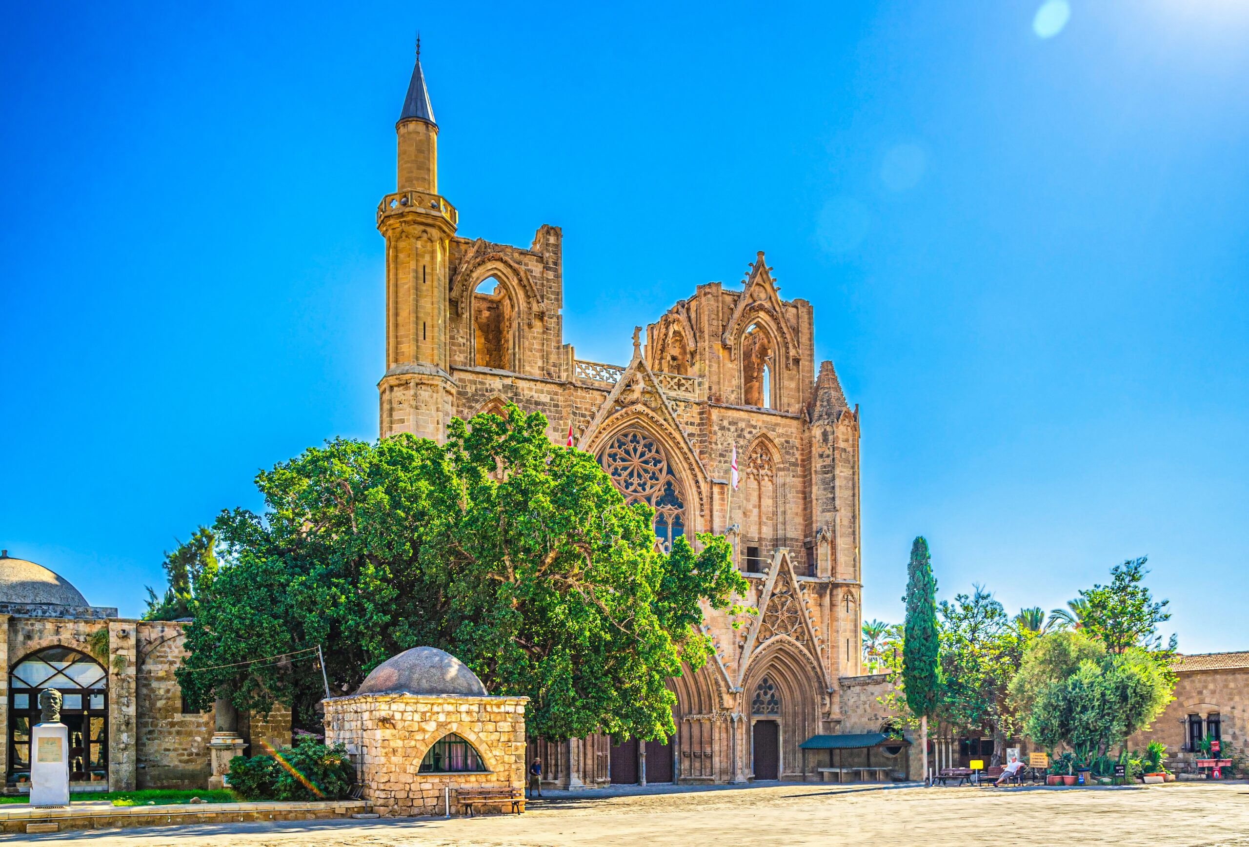 Minaret of Lala Mustafa Pasha Mosque framed by Gothic arches, representing the Ottoman influence in Famagusta, Cyprus.