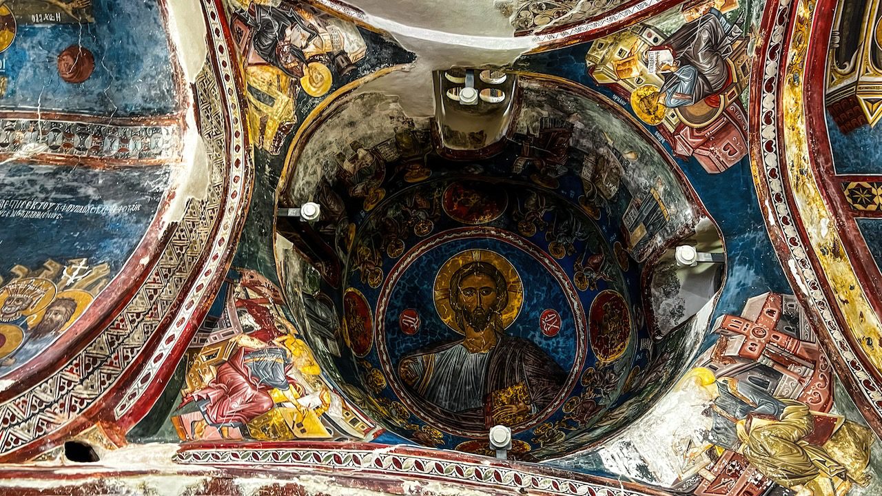 Stunning Byzantine frescoes depicting religious figures on the dome ceiling of Agios Nikolaos tis Stegis Church in Cyprus.