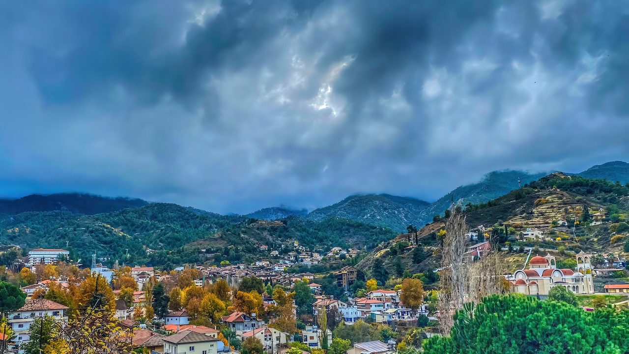 Overlooking view of Galata Village nestled in the verdant Solea Valley under a dramatic sky in Cyprus.