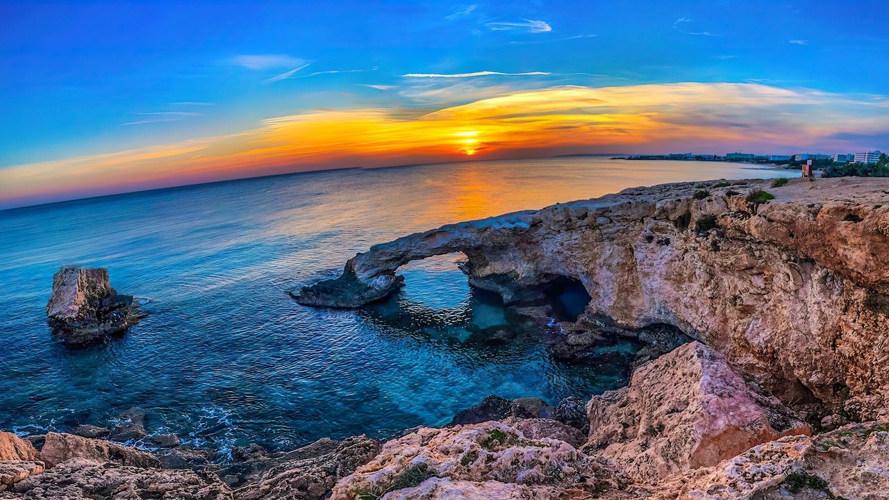 Love Bridge, Ayia Napa's natural stone arch, captured at sunset, embodying the beauty of Cyprus's landscape.