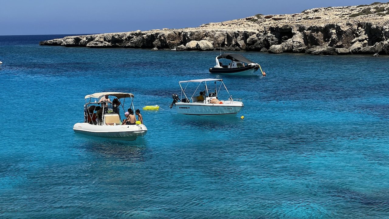 Speedboats anchored in the crystal-clear waters of Famagusta, Cyprus during summer.